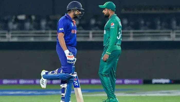 India skipper Rohit Sharma and Pakistan batter Babar Azam stand face-to-face during a cricket match. — ICC