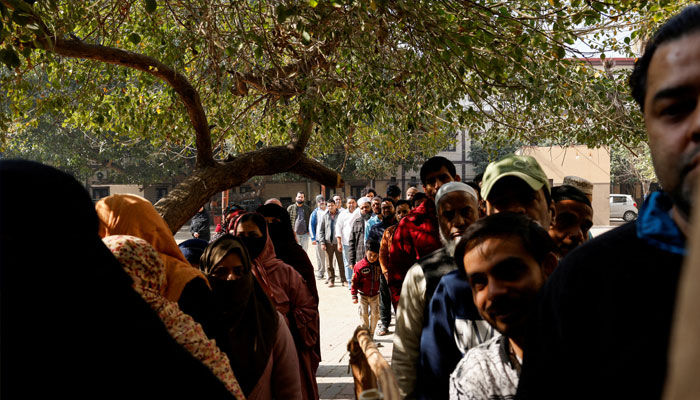 People stand in queue as they are waiting for their turn to vote at polling station during the state assembly election in New Delhi, India, February 5, 2025. — Reuters