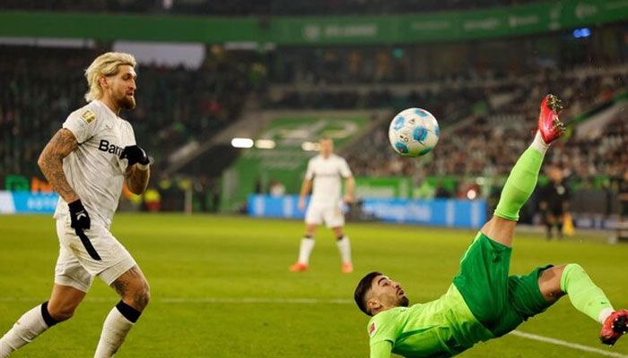 Wolfsburg’s Algerian forward Mohammed Amoura makes an overhead kick past Bayer Leverkusen’s German midfielder Robert Andrich during their Bundesliga match in Wolfsburg, northern Germany on Feb. 8, 2025. —AFP