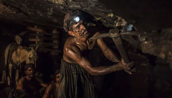 Miner Mohammad Ismail digs in a coal mine in Choa Saidan Shah, Punjab province, April 29, 2014. — Reuters