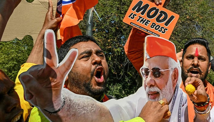 Supporters of the Bharatiya Janata Party (BJP) celebrate as BJP leads in vote counting for the Delhi legislative assembly election outside the party´s state headquarters in New Delhi on February 8, 2025. — AFP