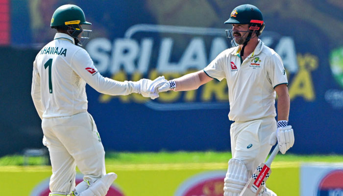 Australias Usman Khawaja (left) and teammate Travis Head bump fists on the fourth day of the second Test against Sri Lanka in Galle, February 9, 2025. — AFP