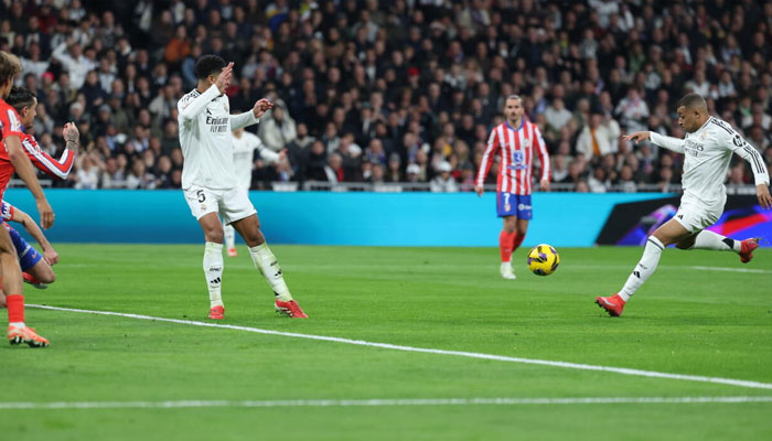 Real Madrids Kylian Mbappe (right) levels for his side in the derby clash against Atletico Madrid. —AFP/File
