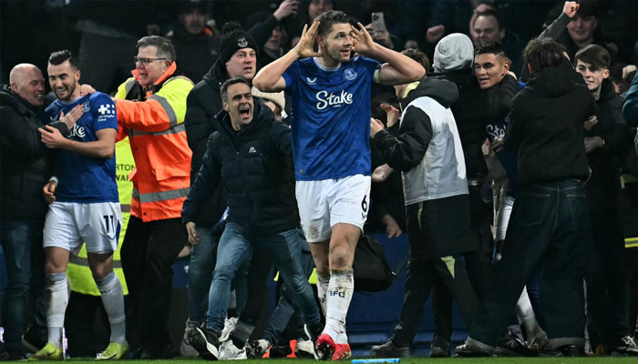 James Tarkowski is mobbed by fans as he celebrates scoring Evertons second goal. —AFP/File