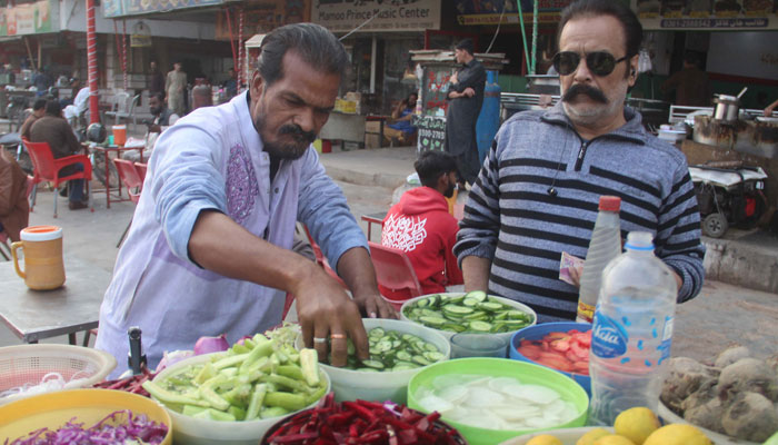 A street vendor is selling salad at Liaqatabad in Karachi.— Online/File
