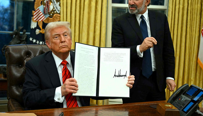 US President Donald Trump speaks to the press after signing an executive order, alongside US Secretary of Commerce nominee Howard Lutnick (right), in the Oval Office of the White House in Washington, DC, on February 10, 2025. — AFP