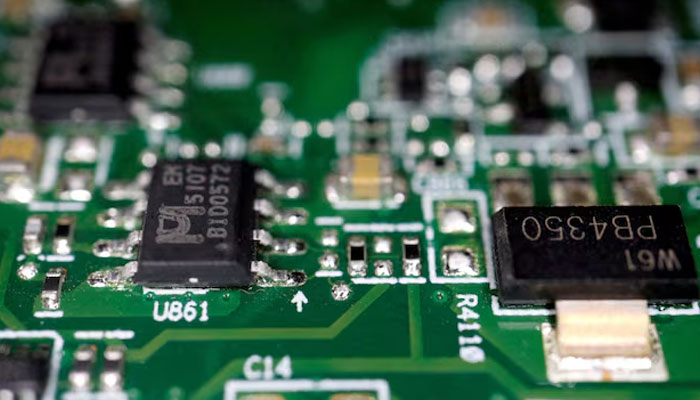 Semiconductor chips are seen on a printed circuit board in this illustration picture taken February 17, 2023. —Reuters