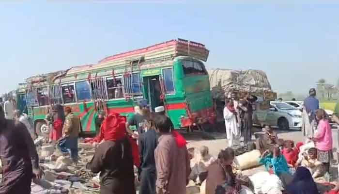 The image shows pilgrims standing around buses on February 15, 2024. — Geo News