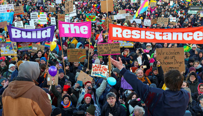 Demonstrators hold placards during a protest against right-wing extremism, racism and for social justice, ahead of the upcoming general election, in Berlin, Germany on February 16, 2025. —Reuters