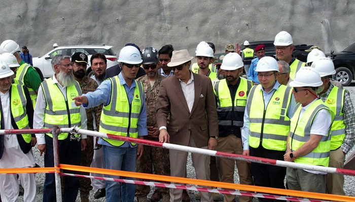 WAPDA Chairman Lt Gen Sajjad Ghani (retd) is briefed by officials on his visit to Diamer Basha Dam on May 17, 2024. — Reporter
