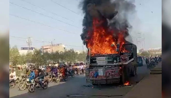 View of a burning dumper, which was torched by an angry mob after an accident killed a motorist in Karachi on October 28, 2024. — PPI