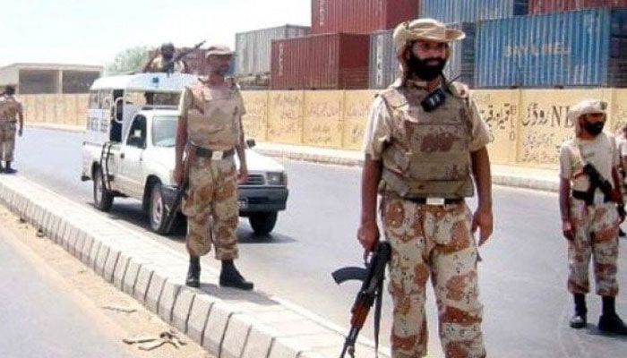 Sindh Rangers personnel stand guard on the road in Karachi. — APP/File