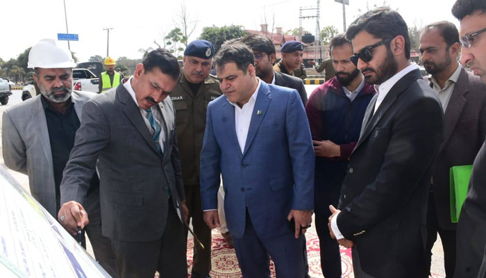 Commissioner Rawalpindi Division Engineer Aamir Khattak (centre) is being briefed about the progress of the construction work of the Khawaja Corporation Flyover on February 18, 2025. — Facebook