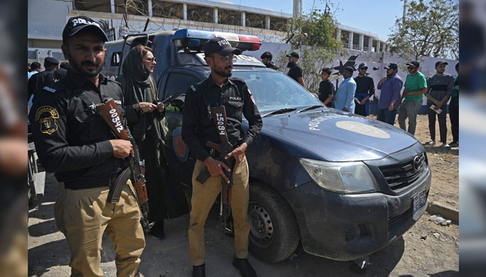 Security personnel stand guard outside the National Stadium in Karachi on February 19, 2025. — AFP