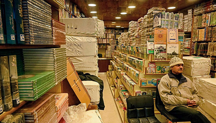 A shopkeeper waits for customers at a bookshop in Srinagar on February 18. — AFP