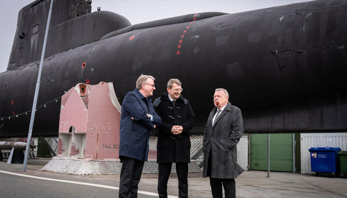Denmarks Minister of Foreign Affairs Lars Lokke Rasmussen (right) standing next to a submarine in Copenhagen.—AFP/File