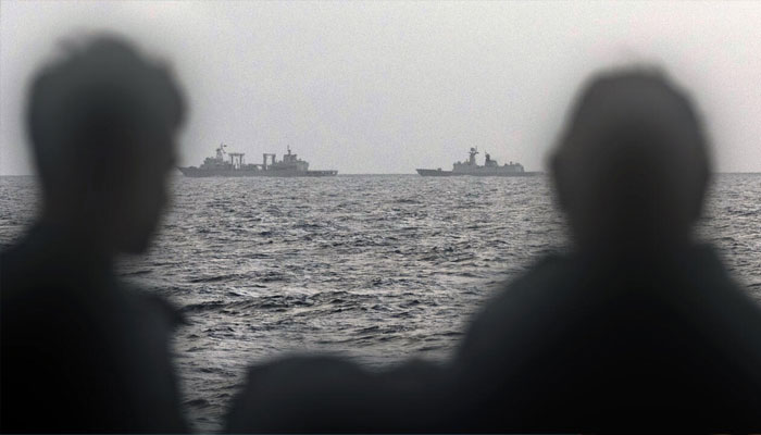 This handout photo taken on February 13 and released by the Australian Defence Force shows sailors onboard the Royal Australian Navy ship HMAS Arunta looking at the Peoples Liberation Army-Navy Fuchi-class replenishment vessel and Weishanhu Jiangkai-class frigate Hengyang in the Tasman Sea. — AFP/File