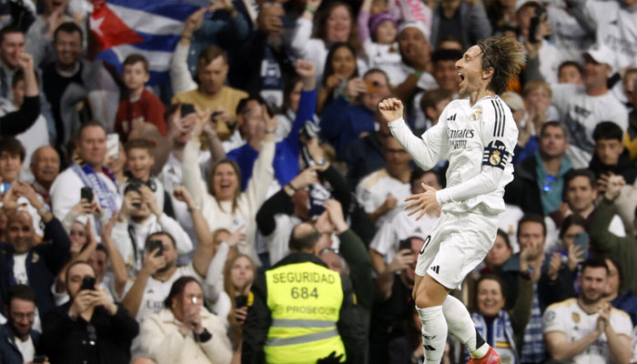 Real Madrids Croatian midfielder Luka Modric celebrates scoring the opening goal against Girona on Sunday. —AFP/File