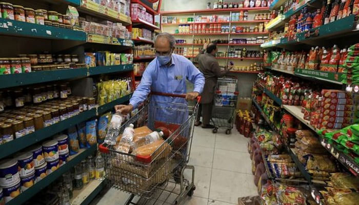 A person shops for grocery items at a store in Peshawar on April 9, 2021. —  Reuters