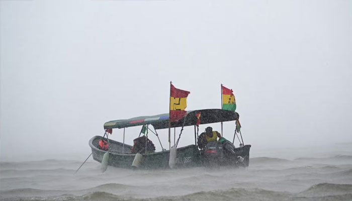 A boat of indigenous Gunas sails under heavy rain and wind in the port of Carti, Guna Yala territory, Panama on 22 February 2025. — AFP