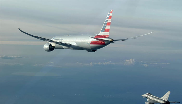 This handout picture taken and released by the Italian Air Force shows the American Airlines flight being escorted by a fighter jet, February 23, 2025. —AFP