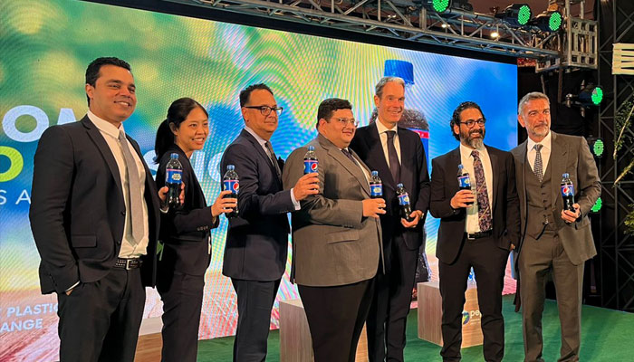 Pepsi officials holding pepsi bottles for a photo. — Pepsi co pk website/File
