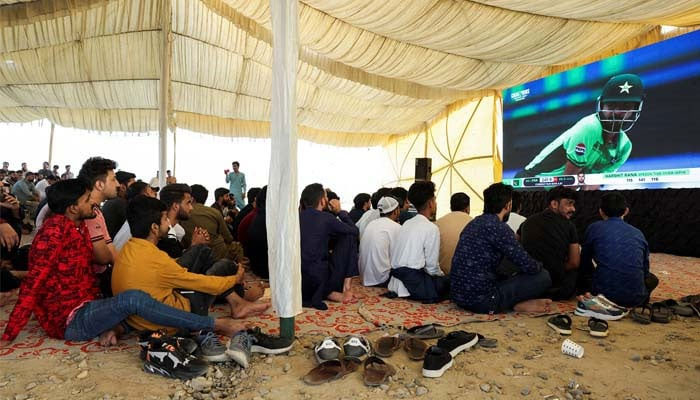 Pakistani cricket fans watch a match between India and Pakistan on a big screen, during the ICC Mens Champions Trophy, in Karachi, Pakistan, February 23, 2025. — Reuters