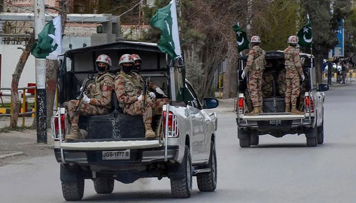 Security personnel patrol with vehicles on a street in Quetta on March 25, 2020. — AFP