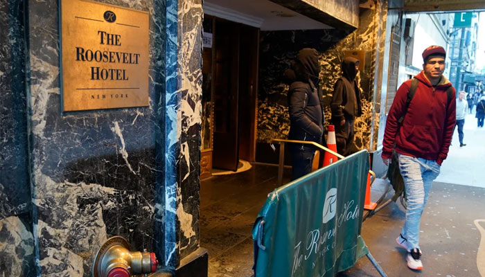 People come out of the Roosevelt Hotel migrant center in Midtown on February 24, 2025 in New York City.— AFP
