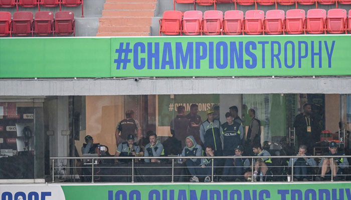 Australia players watch from their balcony as the rain comes down in Rawalpindi, February 25, 2025. —AFP