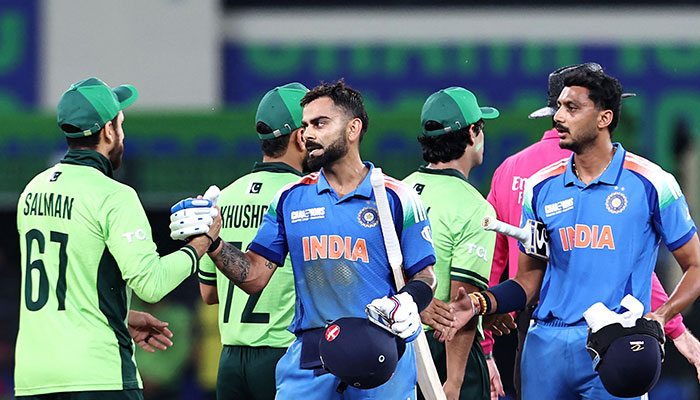 India´s Virat Kohli (centre) and Axar Patel (right) shake hands with Pakistan´s players at the end of the ICC Champions Trophy one-day international (ODI) cricket match between Pakistan and India at the Dubai International Stadium in Dubai on February 23, 2025. —AFP