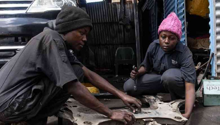 Anastacia Mwende (right) works on a clients car as she takes a course in mechanics, specialising in diagnosing and repairing of German machines at a garage in Nairobi on February 12, 2025.— AFP