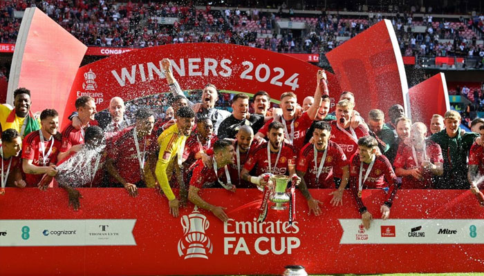 Manchester United players seen celebrating with the trophy.— AFP/File