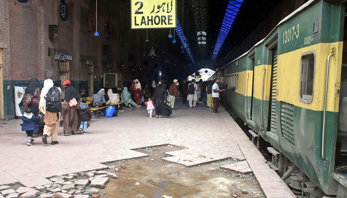 People wait to board a train at a railway station in Lahore on February 26, 2025. — Online