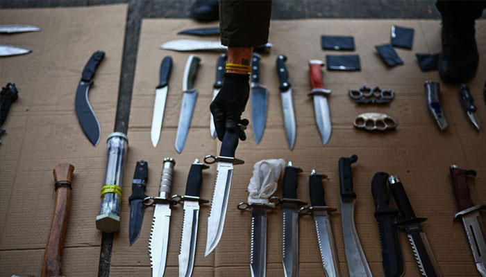 A person holding a knife.— AFP/File