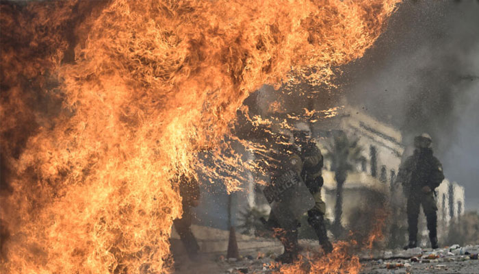 Riot police clash with protesters who threw petrol bombs outside the Greek parliament. — AFP/File