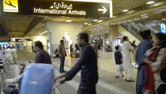 Passengers walk after their arrival at the Jinnah International Airport in Karachi on January 31, 2020.  — AFP