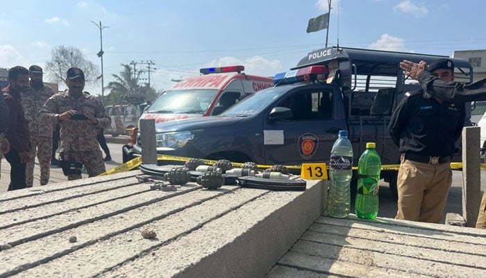 Police and paramilitary personnel are seen observing the site of attack in Landhi, Karachi, on April 19, 2024. — Geo News
