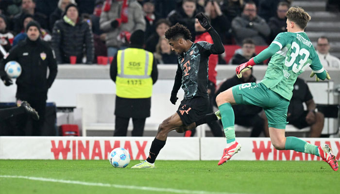 Kingsley Coman (left) catches Stuttgart goalkeeper Alexander Nuebel. —AFP/File