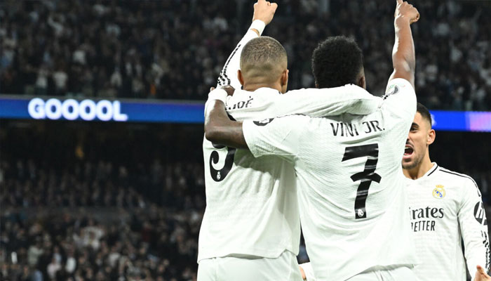 Real Madrids French forward Kylian Mbappe celebrates with Vinicius Junior during the win over Manchester City, March 2, 2025 . —AFP