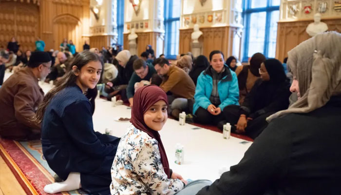 Attendees gathered in rows to break their fast along the length of St Georges Hall, March 3, 2025. —Royal Collection Trust