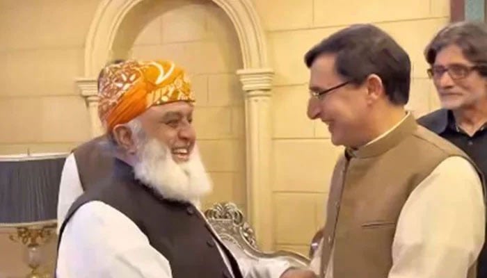 JUIF Chief Maulana Fazlur Rehman (left) shakes hands with PTI Chairman Barrister Gohar Khan in this image released on August 23, 2024. — Screengrab via Facebook@Jamiat Ulama-e-Islam Pakistan