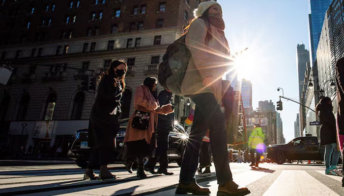 A woman carries a shopping bag during the holiday season in New York City, U.S., December 21, 2022. —Reuters