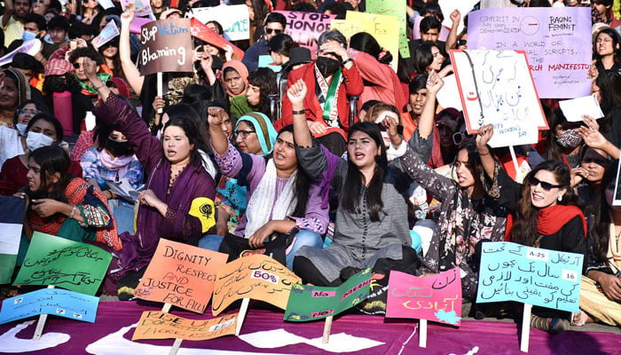 The representational image shows participants displaying placards as a large women from all walks of life participating in a rally (Aurat March) to mark International Womens Day. — APP/File
