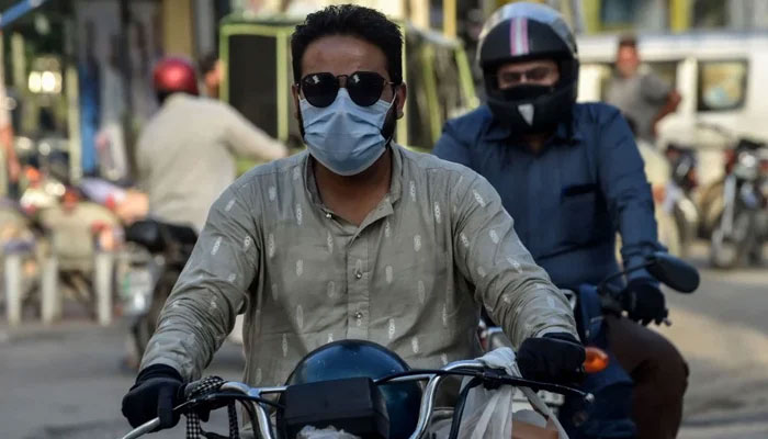 A motorcyclist can be seen without helmet. — AFP/File