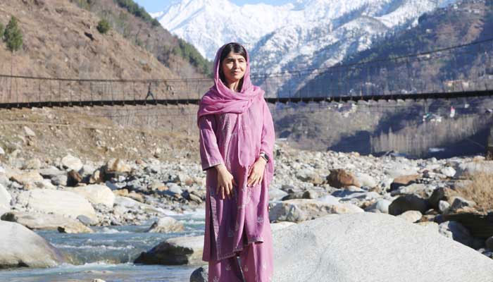 Nobel Peace Prize laureate and education activist Malala Yousafzai poses for a picture at riverside in her home village Barkana, Shangla district, Khyber Pakhtunkhwa, March 5, 2025. — X@Malala