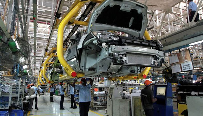 Workers assemble Ford cars at a plant of Ford India in Chengalpattu on the outskirts of Chennai, India March 5, 2012. — Reuters