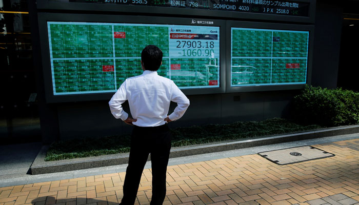 A man watches an electric board showing Nikkei index outside a brokerage in Tokyo, Japan in this 2021 file photo. — Reuters