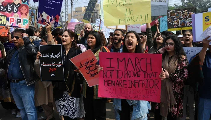 Representational image of demonstrators holding placards and shouting slogans as they march during the Aurat March to mark International Womens Day in Lahore, Pakistan. — AFP/File