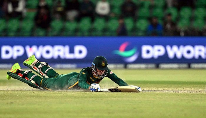 South Africas Rassie van der Dussen dives to reach the crease during the ICC Champions Trophy semi-final match against New Zealand. —  AFP